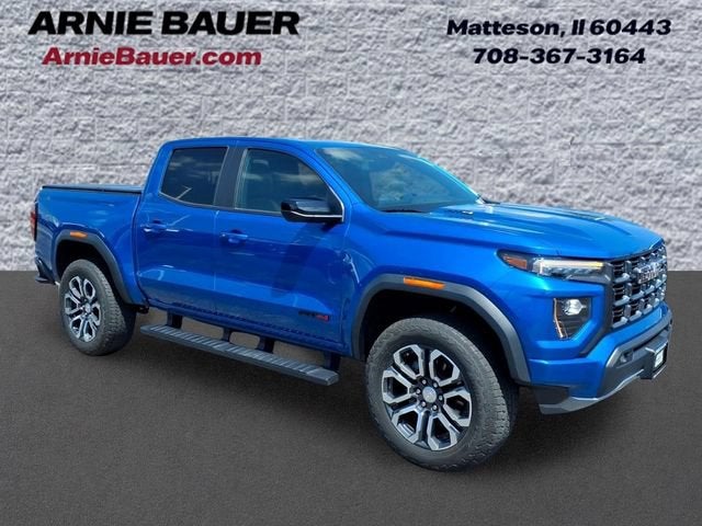 2023 GMC Canyon AT4 in Dynamic Blue Metallic — front three-quarter view