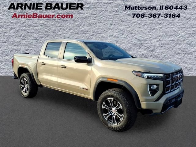 2024 GMC Canyon AT4 in Desert Sand Metallic — front three-quarter view